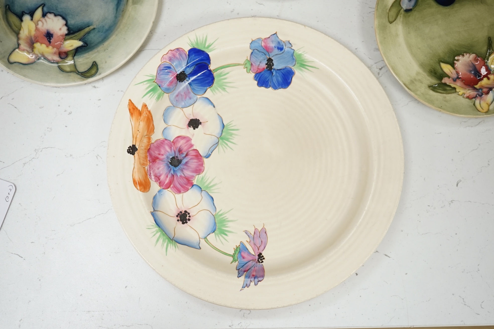 A pair of Moorcroft side plates and two plates Clarice Cliff plates. Condition - fair to good